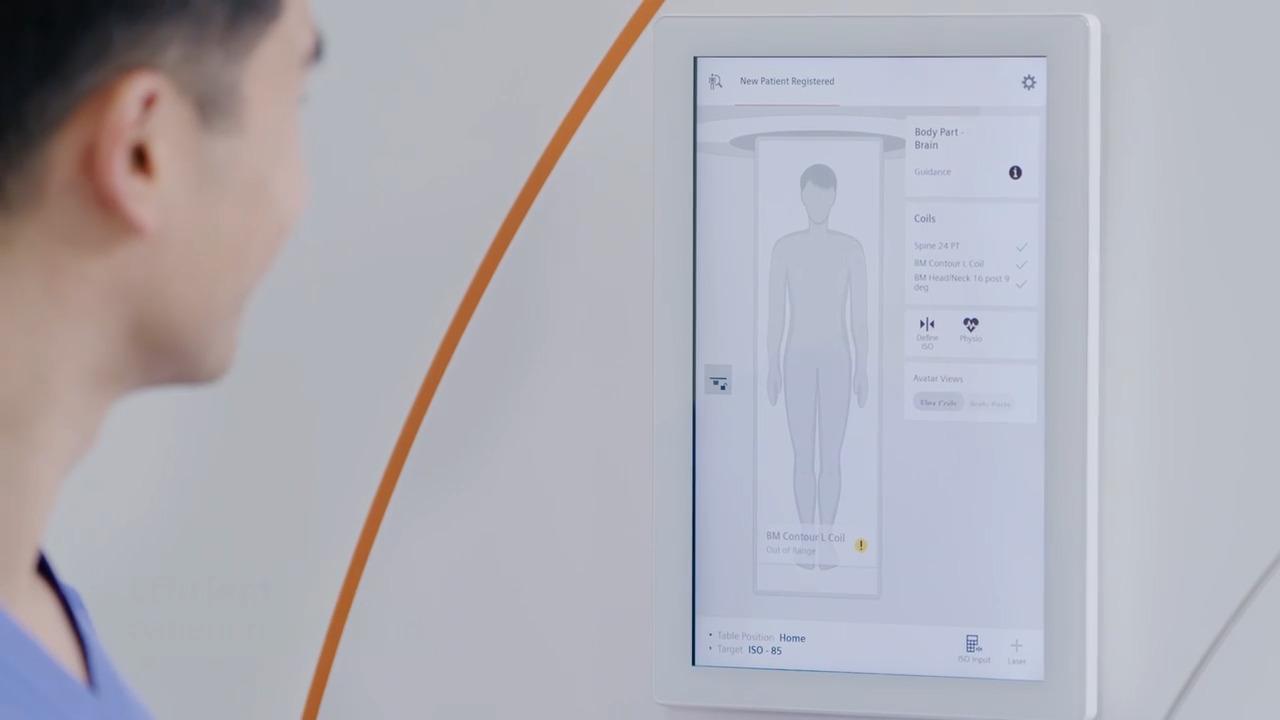 Operator using the MAGNETOM Flow patient-side touchscreen